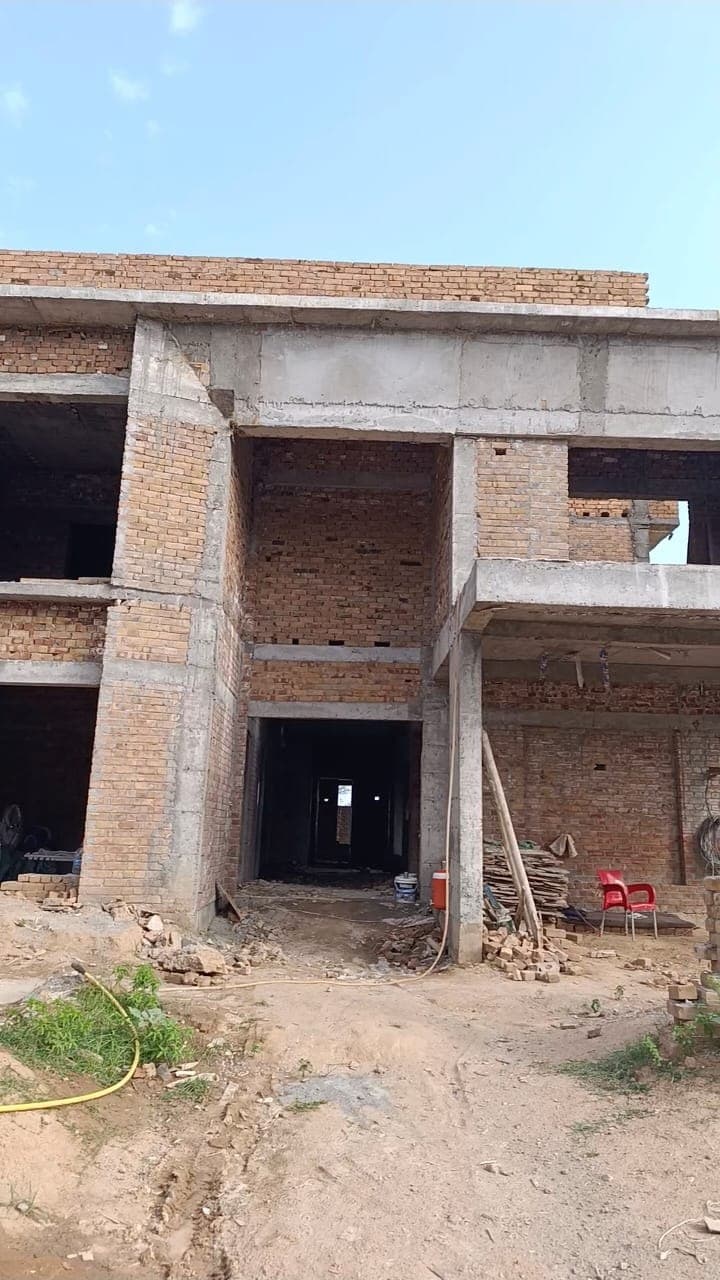 The grey structure on site, brick infill between a reinforced concrete frame