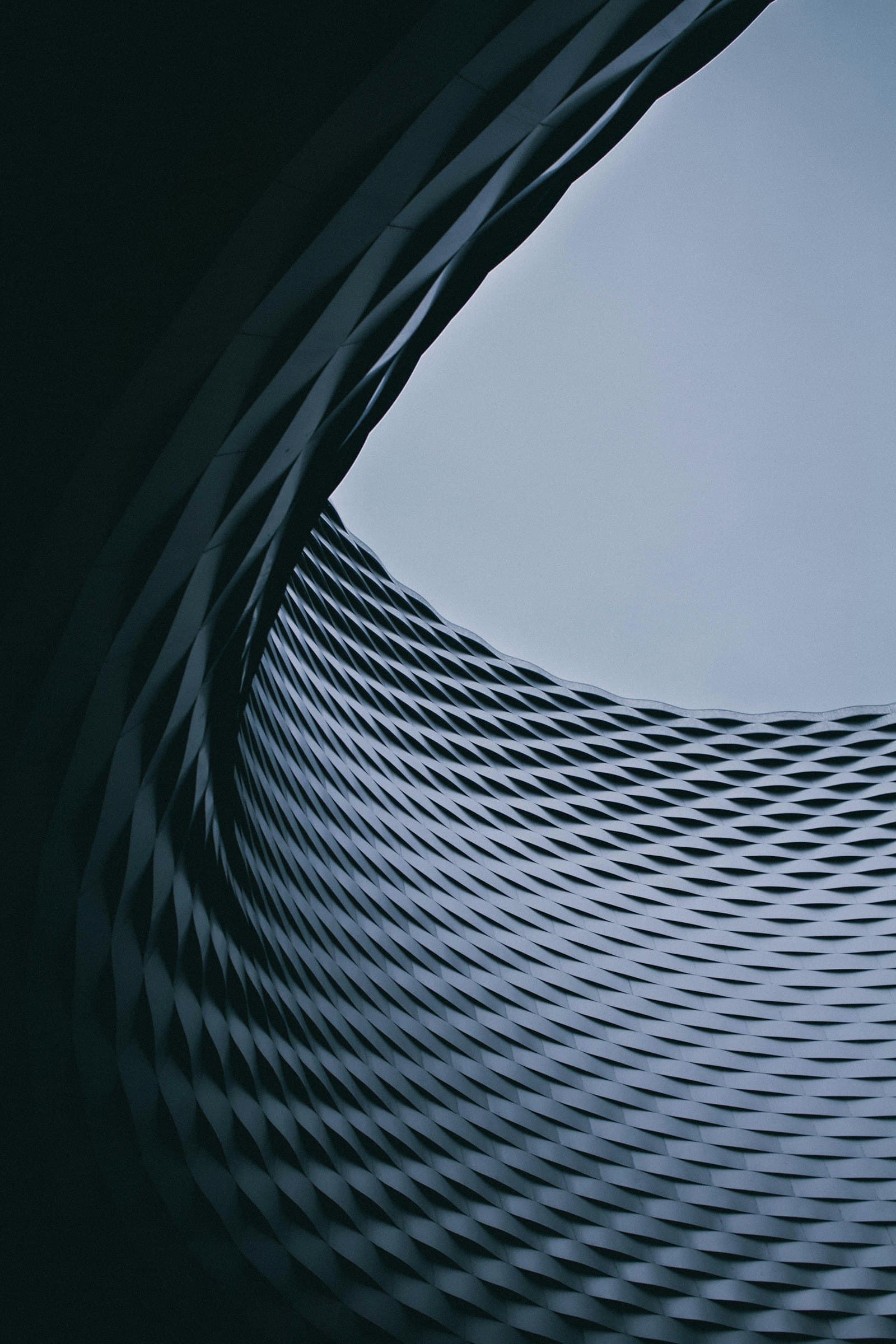 A curved architectural wall in raking light